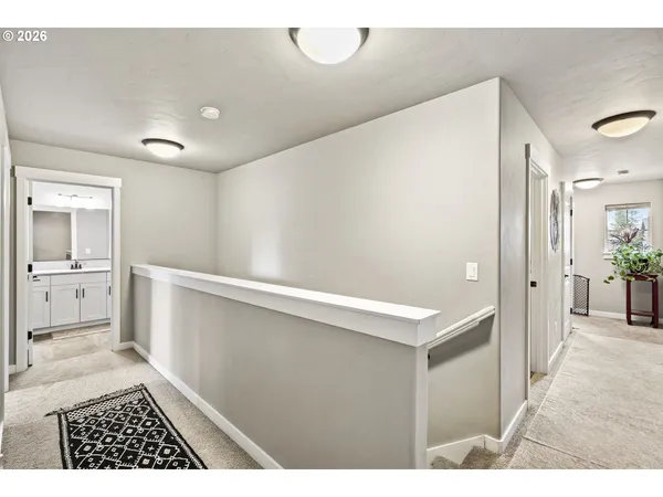 a view of a hallway with bathroom