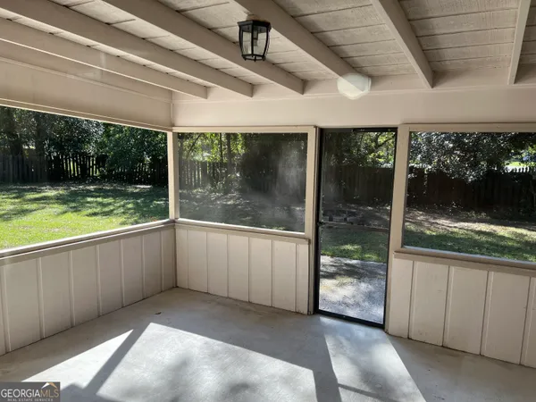 a view of a porch with furniture and garden