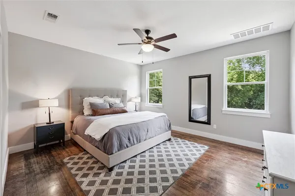 a spacious bedroom with a large bed and a window