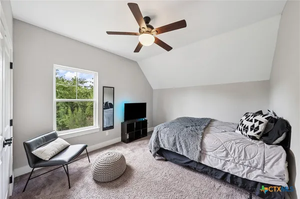 a bedroom with bed and a tv