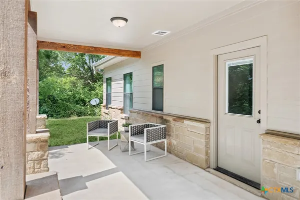 a living room with a floor to ceiling window and a table
