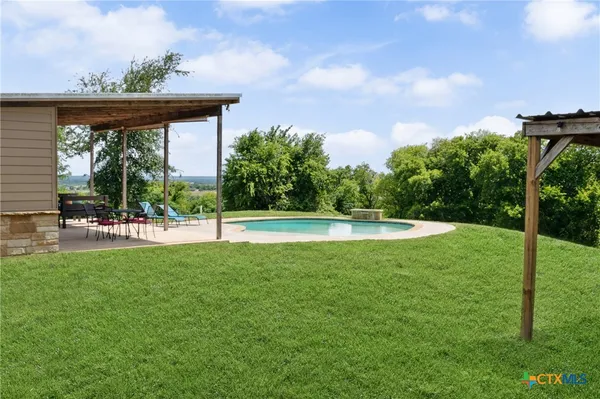 a view of a swimming pool and a yard