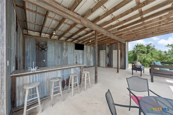 a view of a chairs and table in patio