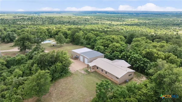 an aerial view of a house with a yard