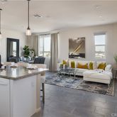 a living room with kitchen island furniture and a chandelier