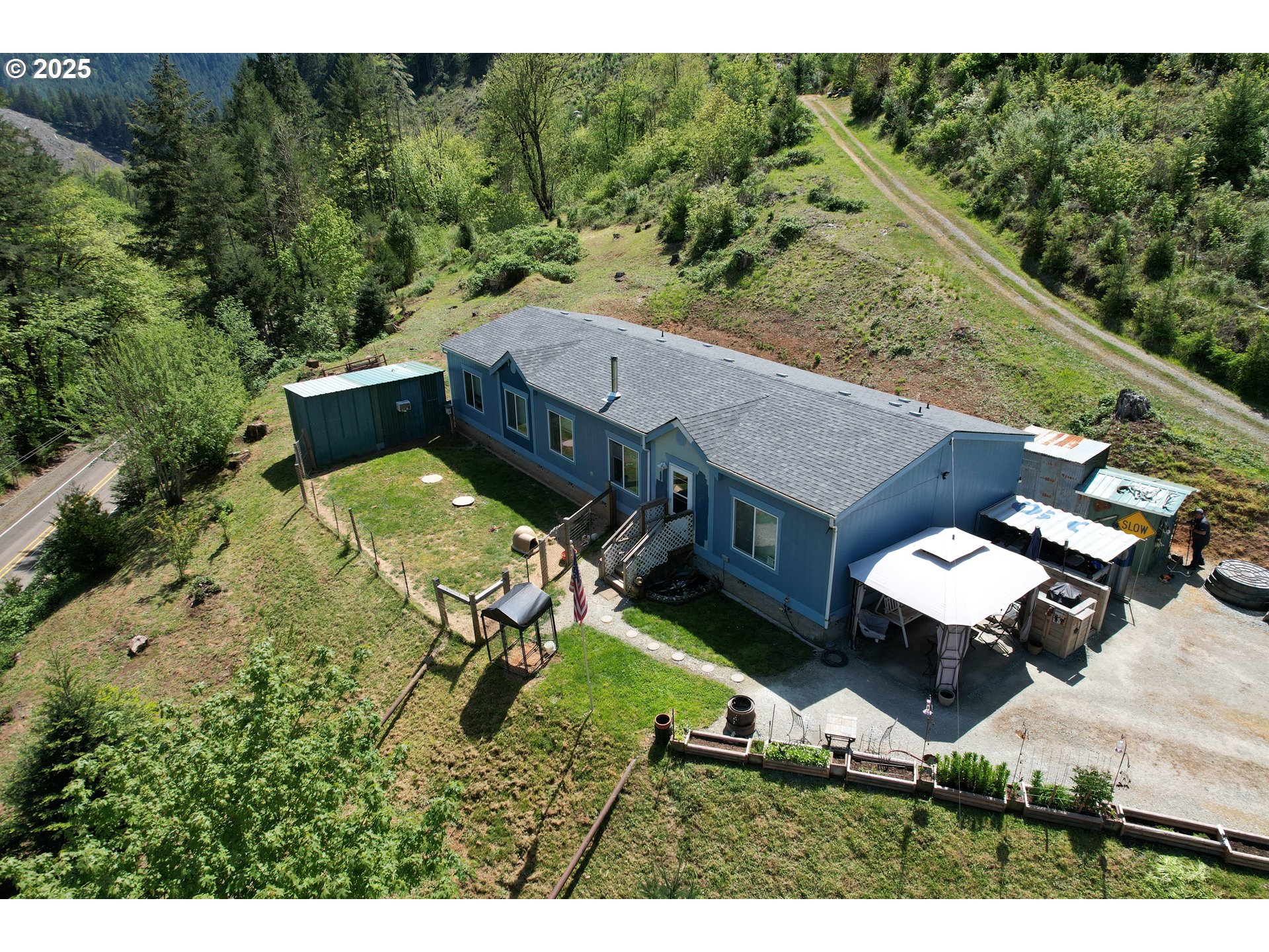 an aerial view of a house with swimming pool and garden view