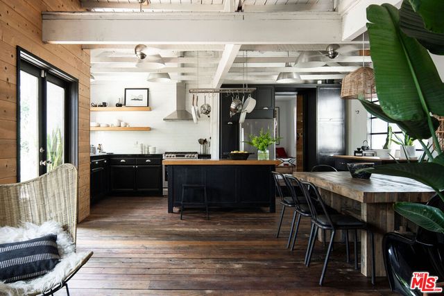 a view of a kitchen with granite countertop a sink and a stove