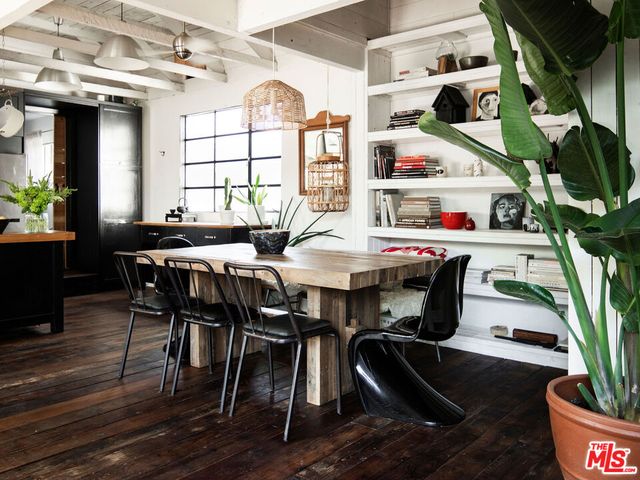 a view of a dining room with furniture and a potted plant