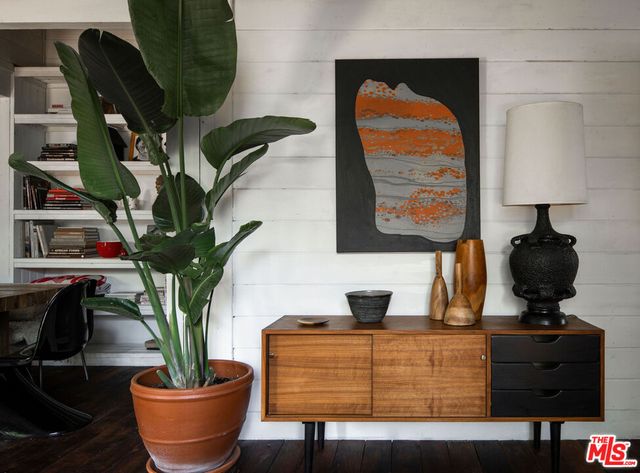a living room with furniture and potted plant