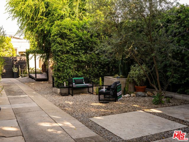 a view of a backyard with table and chairs and couches