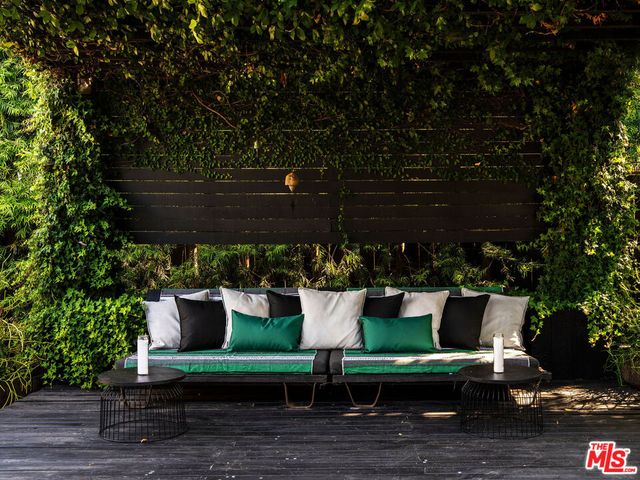 a view of a patio with table and chairs and potted plants