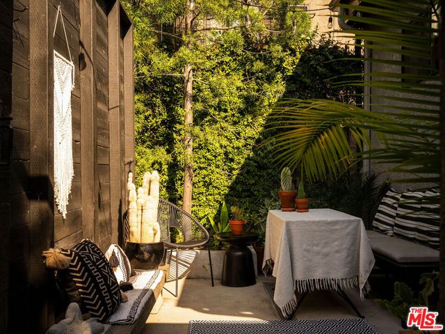 a view of sitting area with furniture and trees