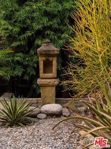 a wooden bench sitting in the middle of a yard