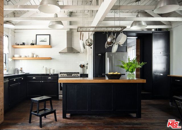 a table and chairs in a kitchen next to a window