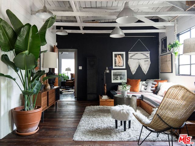 a living room with furniture and a potted plant