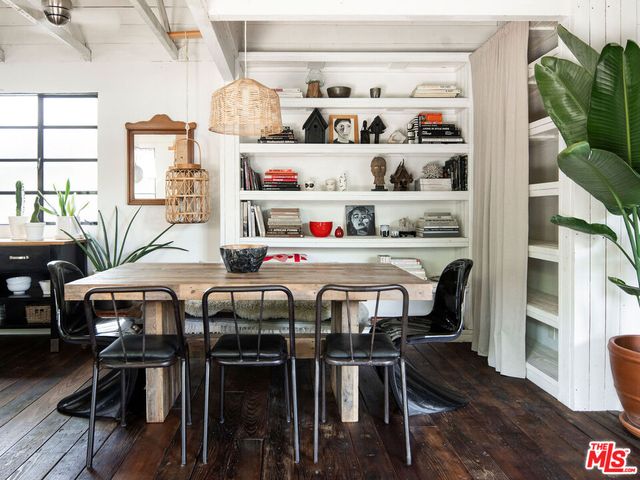 a dining room with furniture and wooden floor