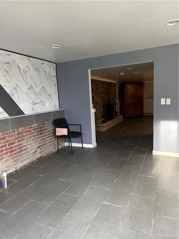 a view of a hallway with seating area