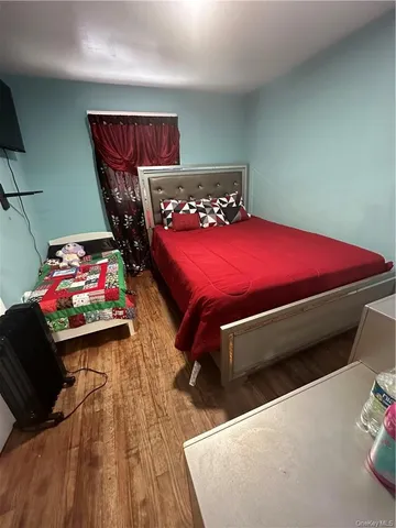 a bedroom with furniture and a wooden floor