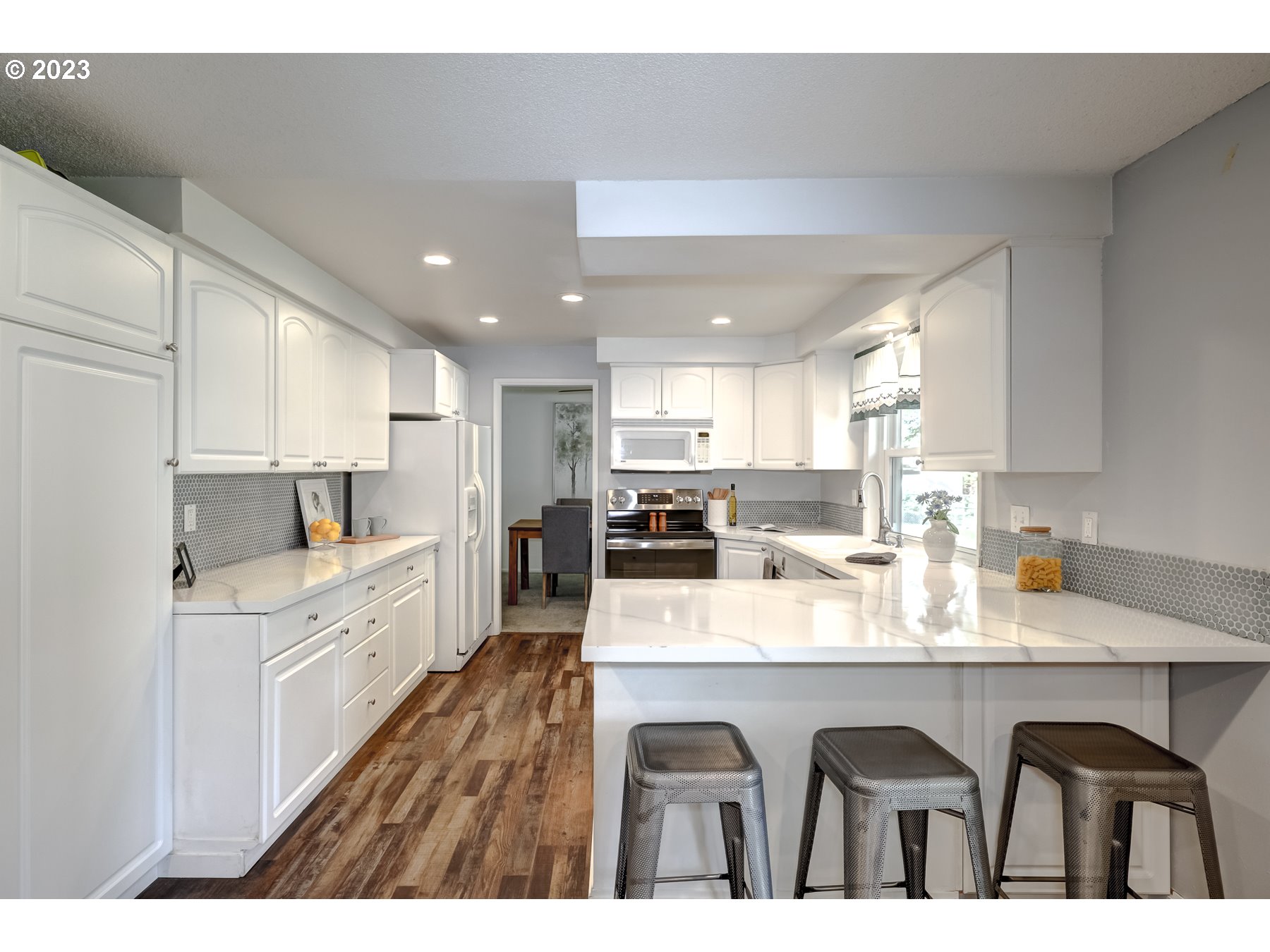 20430 Southwest Avon Court Beaverton, OR 97078 - Photo 13 of 29 a open kitchen with granite countertop a sink and white cabinets