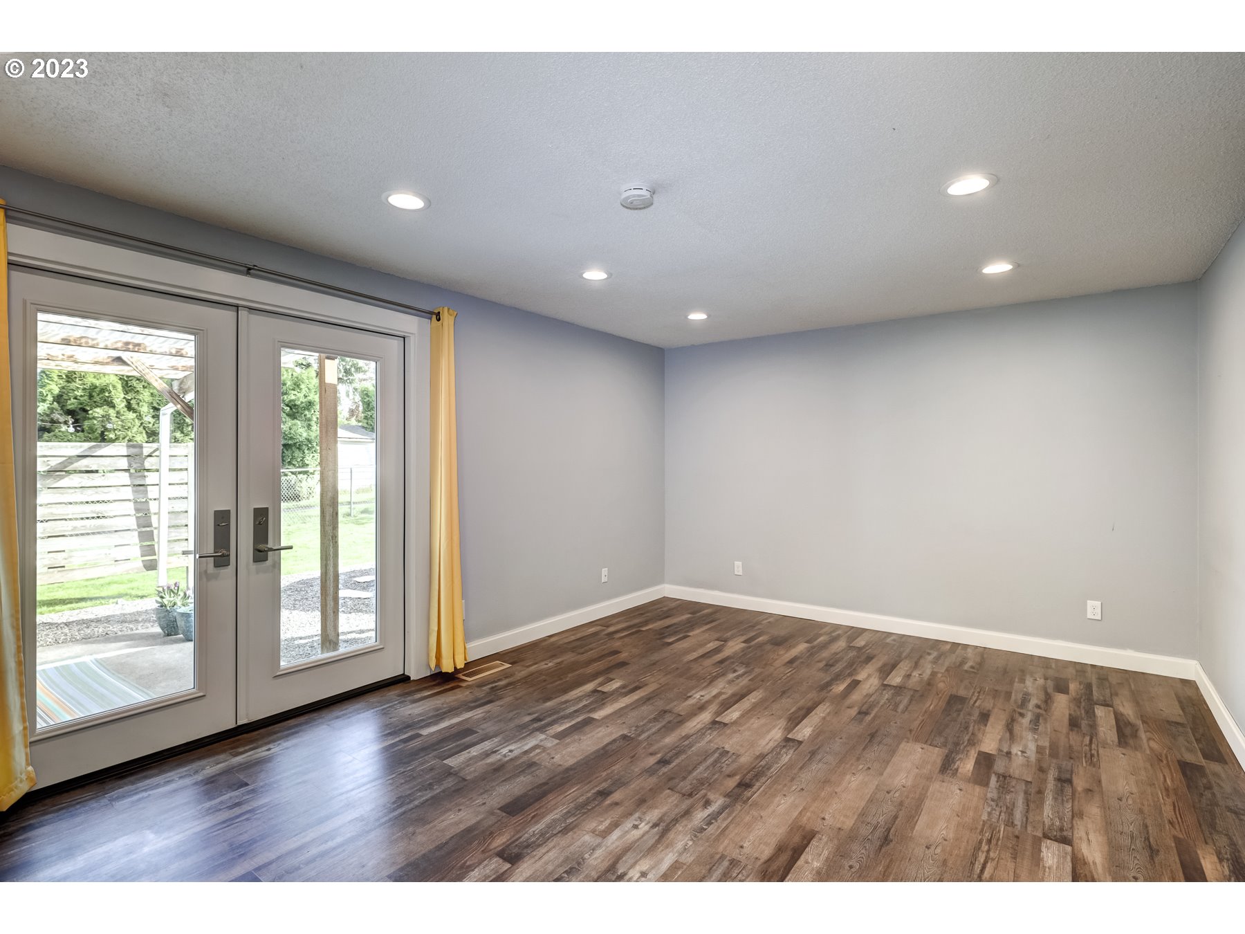 20430 Southwest Avon Court Beaverton, OR 97078 - Photo 16 of 29 a view of an empty room with wooden floor and a window