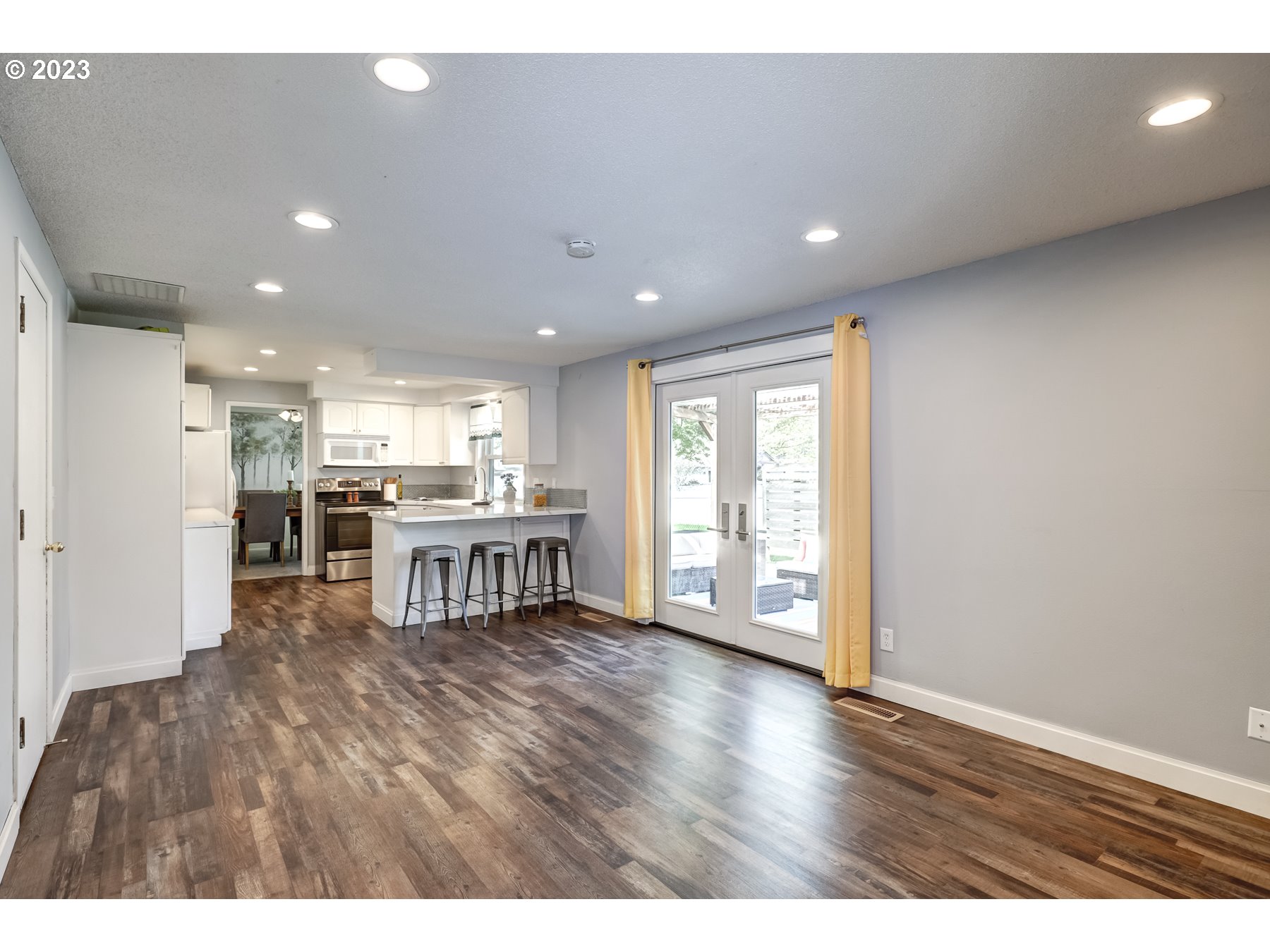 20430 Southwest Avon Court Beaverton, OR 97078 - Photo 17 of 29 a living room with furniture and a kitchen view
