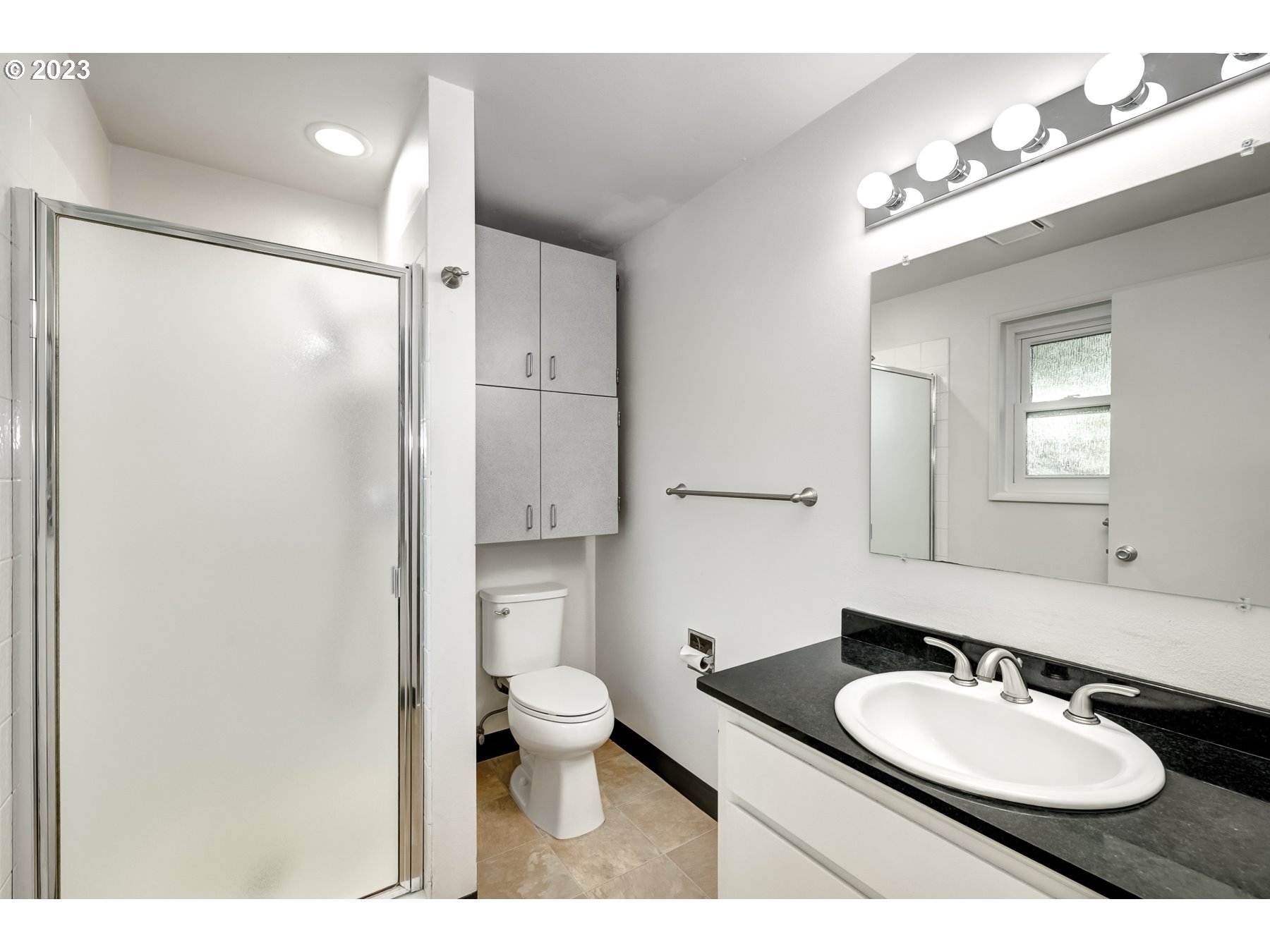 20430 Southwest Avon Court Beaverton, OR 97078 - Photo 20 of 29 a bathroom with a granite countertop sink toilet a mirror and shower