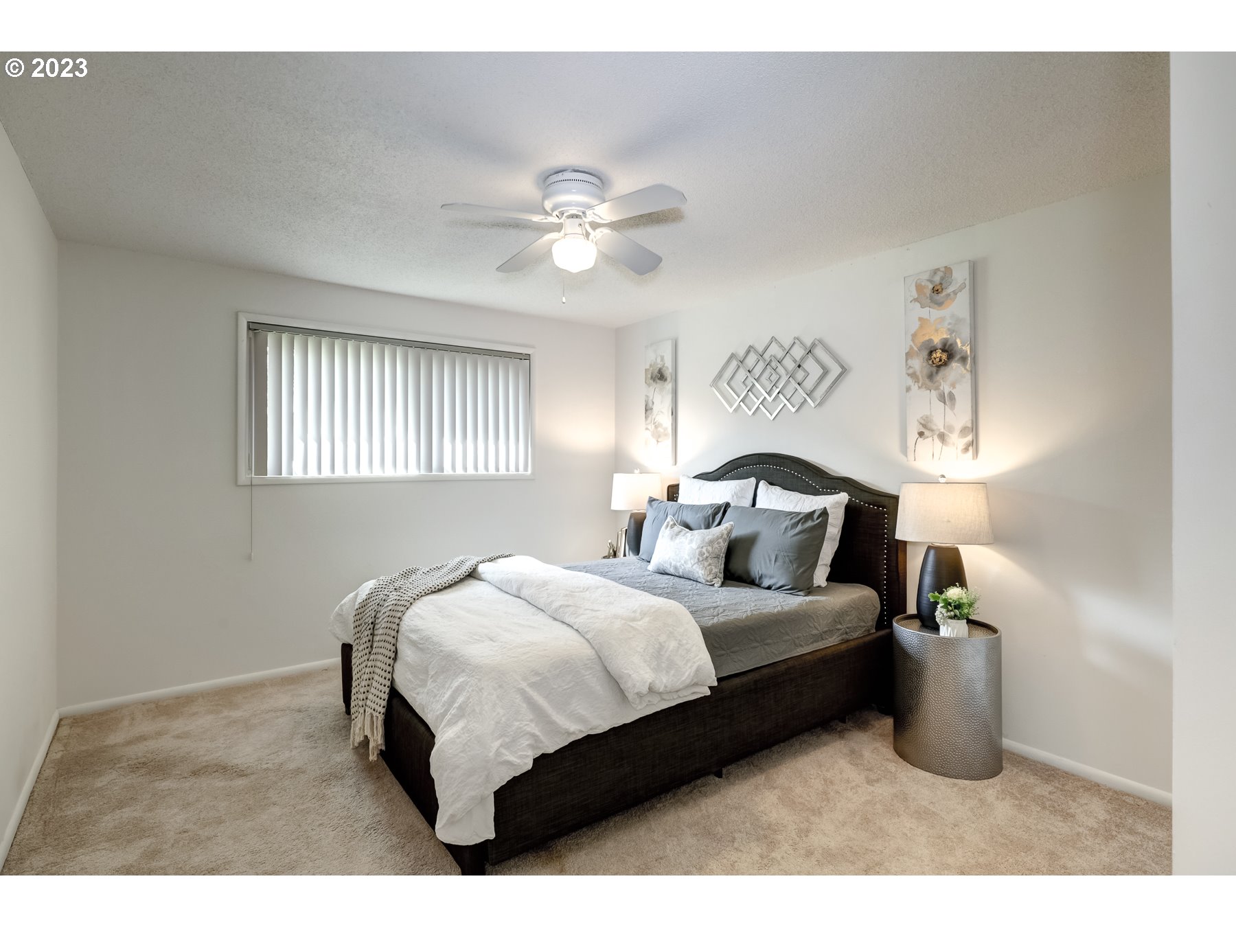 20430 Southwest Avon Court Beaverton, OR 97078 - Photo 22 of 29 a bedroom with a bed and a chandelier