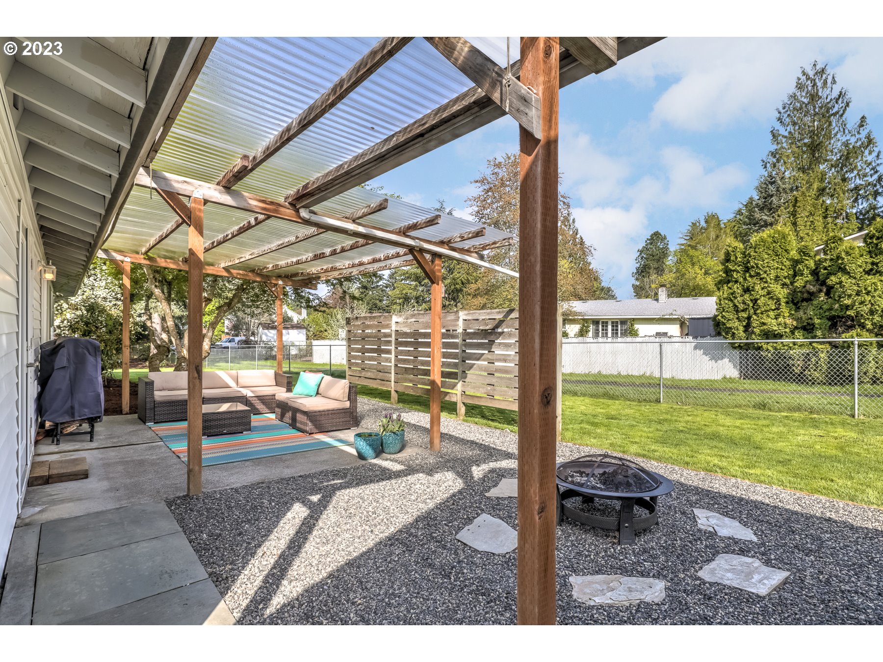 20430 Southwest Avon Court Beaverton, OR 97078 - Photo 25 of 29 a view of a patio with a table and chairs and potted plants
