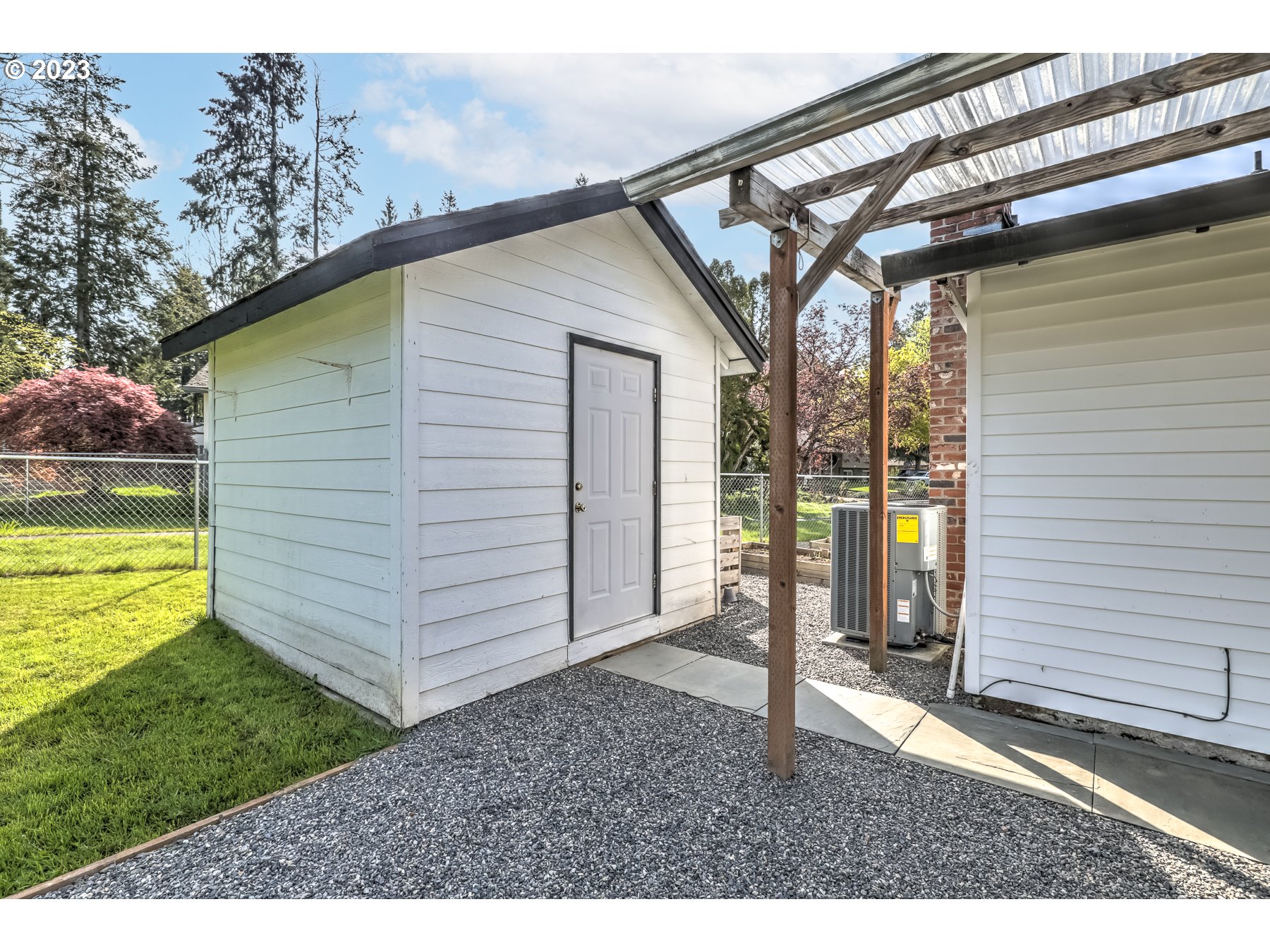 20430 Southwest Avon Court Beaverton, OR 97078 - Photo 28 of 29 a backyard of a house with a fountain and a large tree