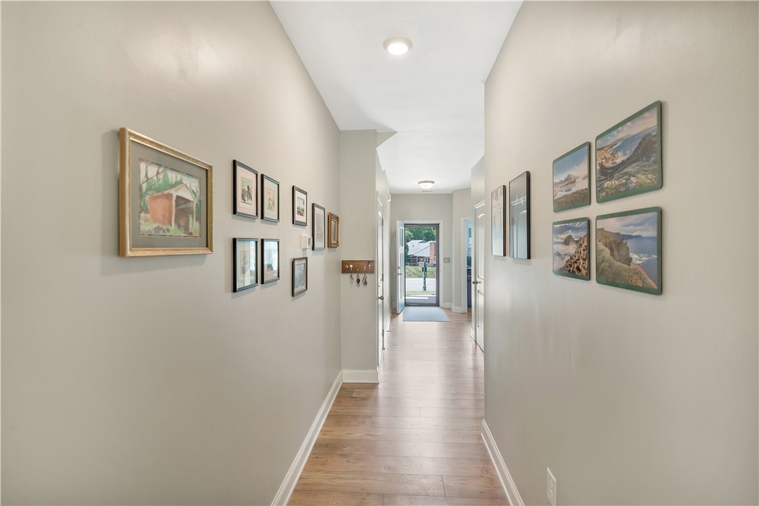 121 Ventura Street Anderson, SC 29621 - Photo 5 of 32 A welcoming entryway hallway with warm hardwood flooring draws the eye towards the front door.