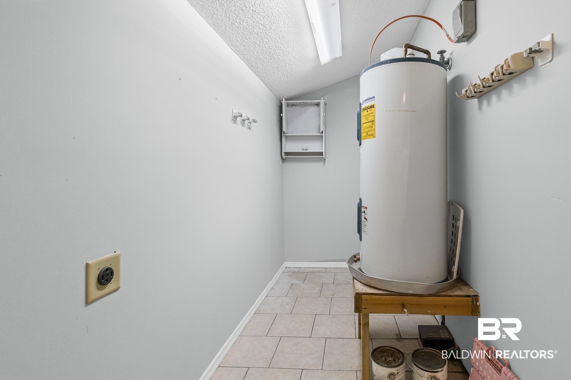6933 Burbank Court Mobile, AL 36619 - Photo 15 of 25 Utility area featuring a water heater, light gray wall paint, and tiled flooring