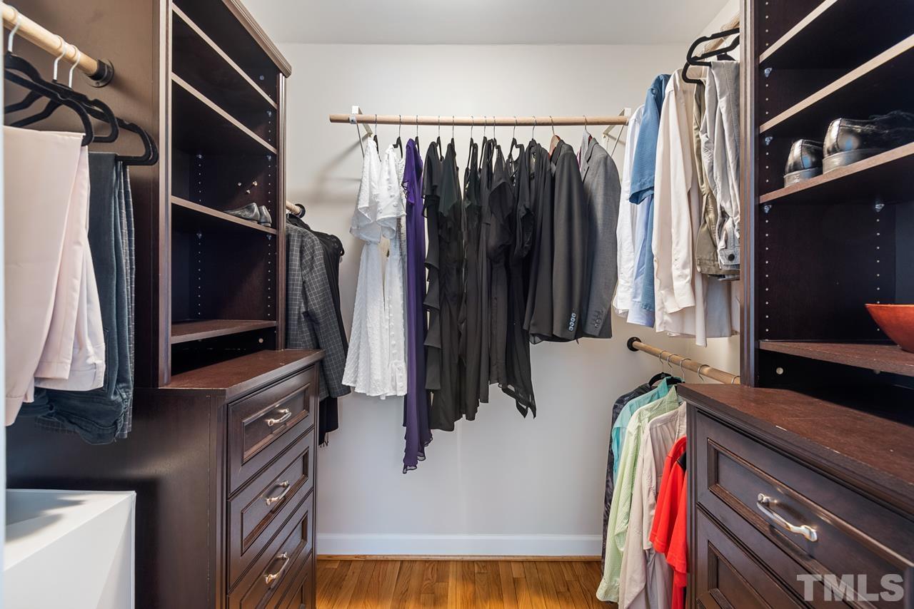 8201 Bromley Road Hillsborough, NC 27278 - Photo 27 of 77 a view of walk in closet with clothes and shoes