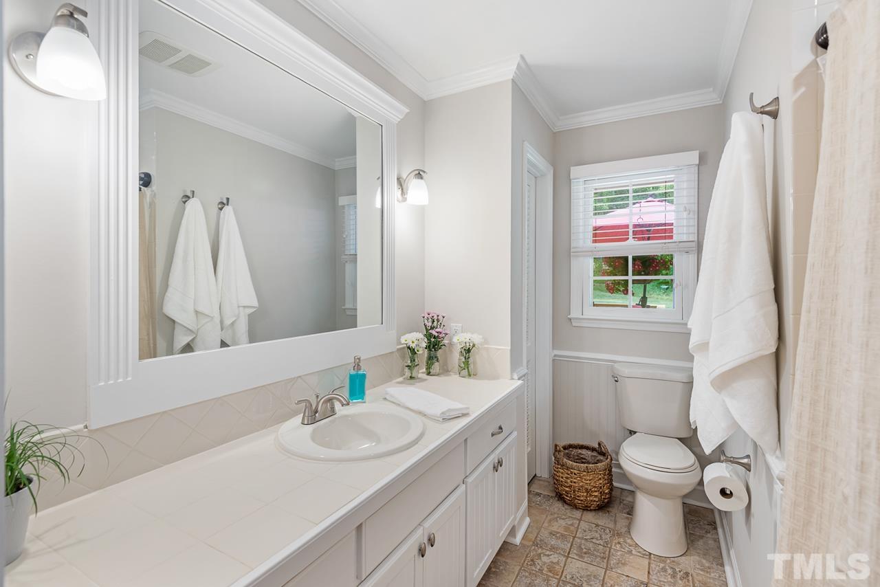 8201 Bromley Road Hillsborough, NC 27278 - Photo 36 of 77 a bathroom with a granite countertop toilet sink and a mirror