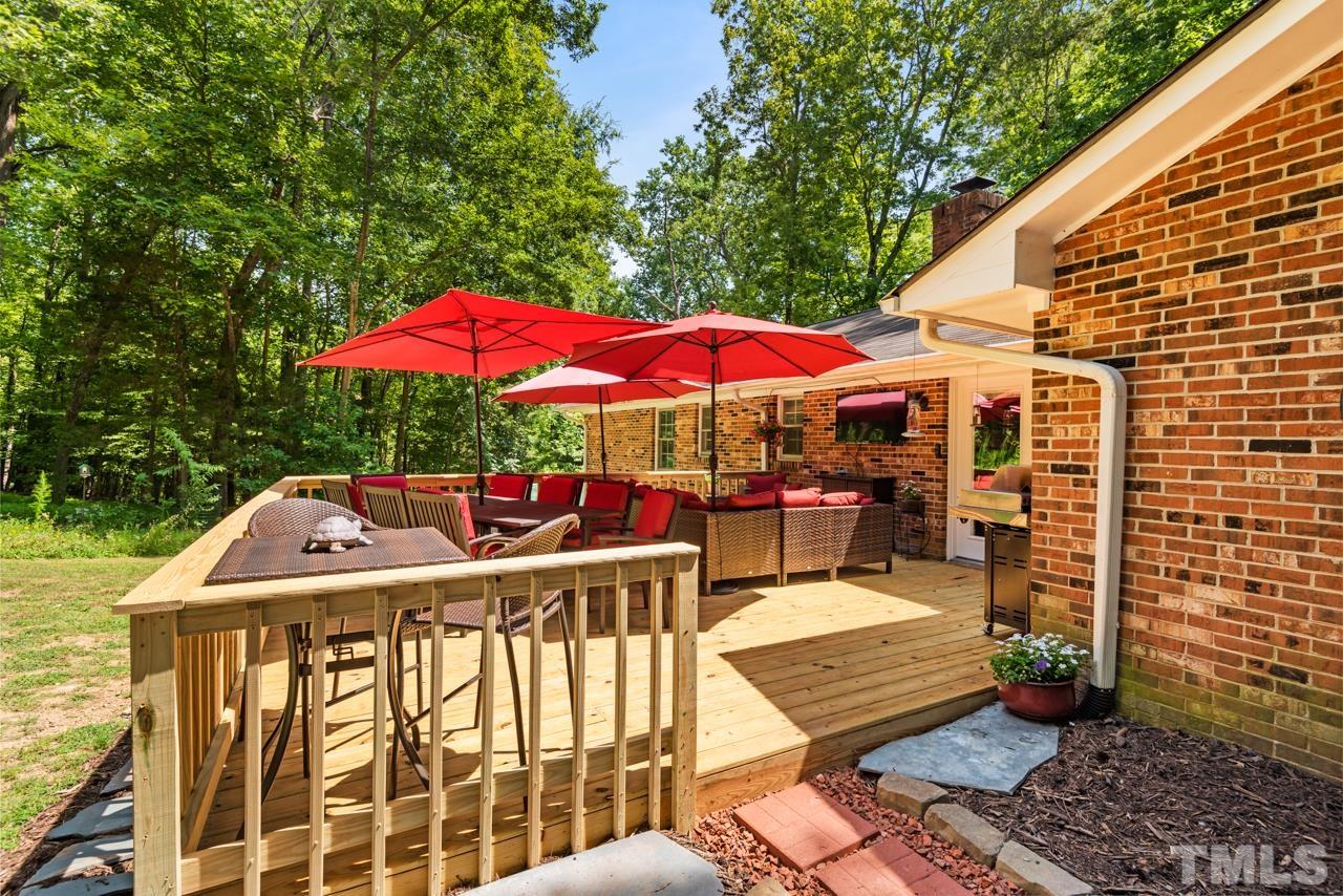 8201 Bromley Road Hillsborough, NC 27278 - Photo 47 of 77 a view of a patio with a table and chairs under an umbrella