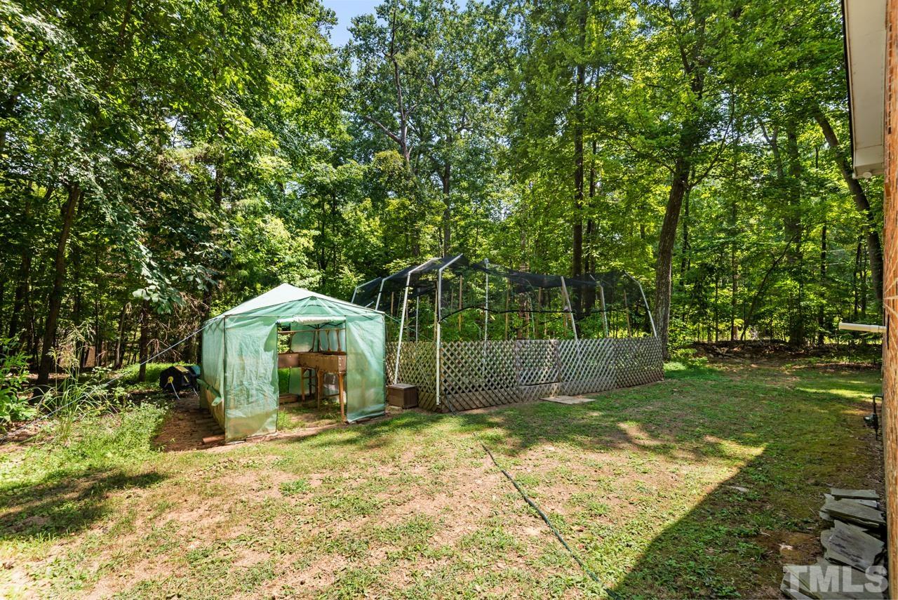 8201 Bromley Road Hillsborough, NC 27278 - Photo 64 of 77 a view of a wooden house with a yard