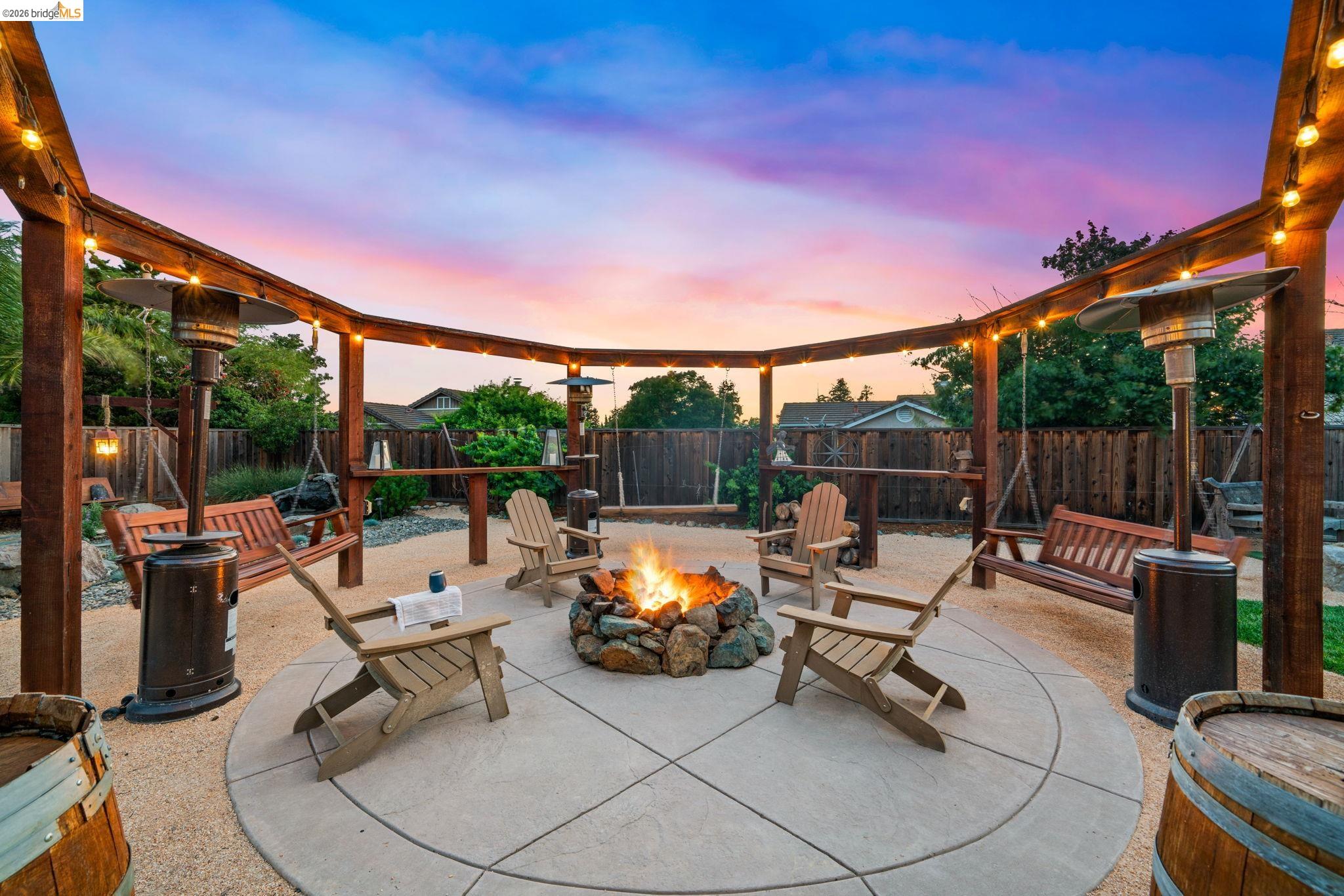 1186 El Rio Court Livermore, CA 94551 - Photo 26 of 60 Outdoor entertainment area featuring a circular concrete patio with a central stone fire pit