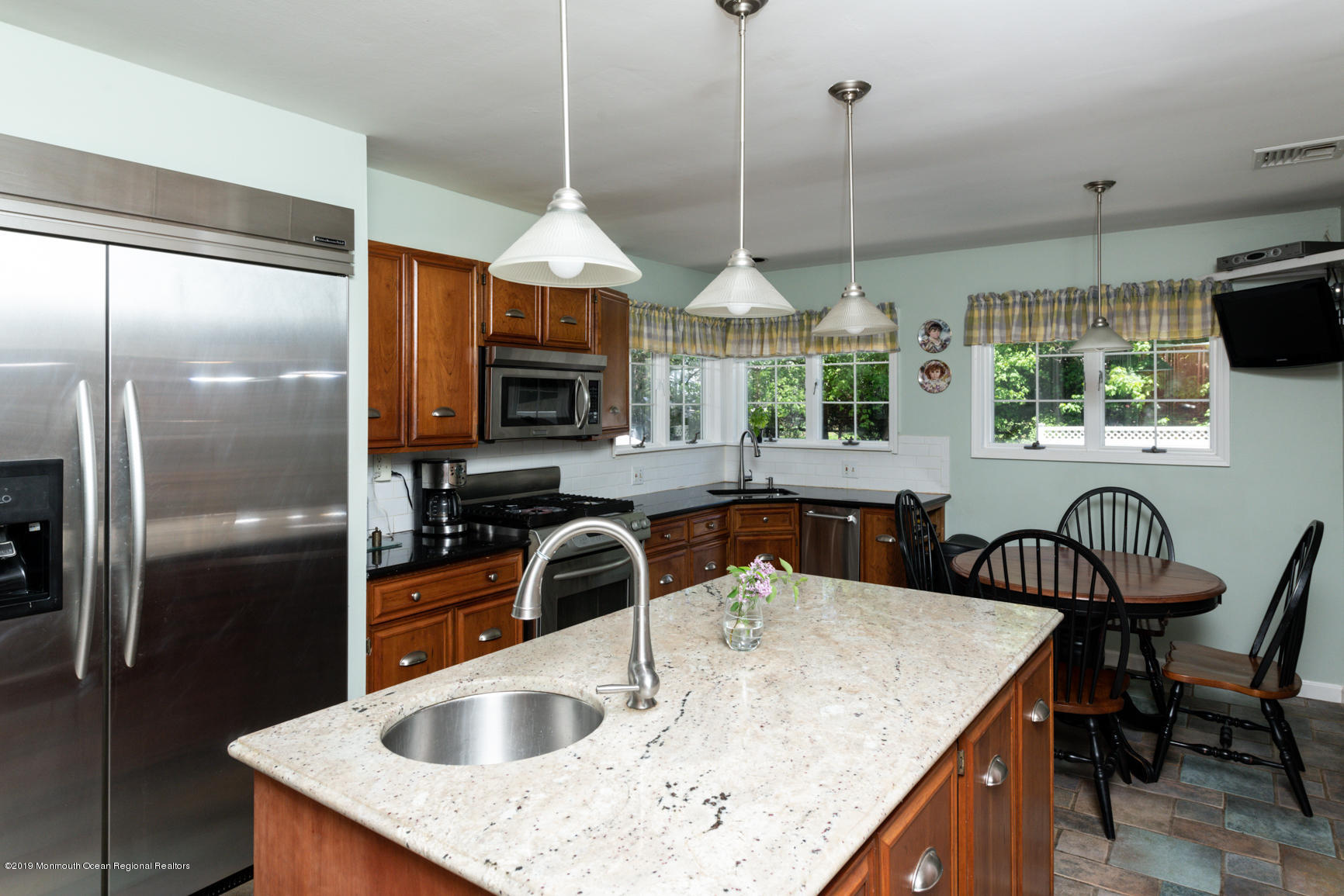 10 Gull Road Middletown, NJ 07748 - Photo 12 of 18 a kitchen with stainless steel appliances granite countertop a sink a stove and a refrigerator