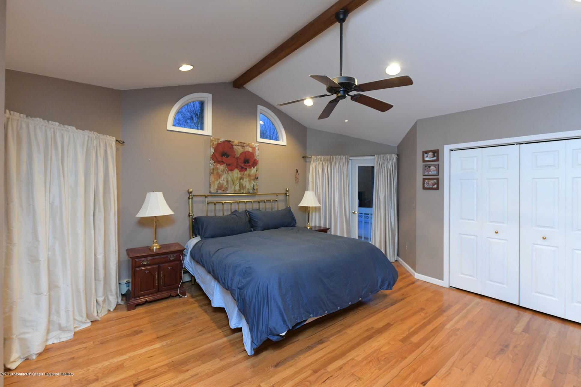 10 Gull Road Middletown, NJ 07748 - Photo 16 of 18 a bedroom with a bed and a chandelier