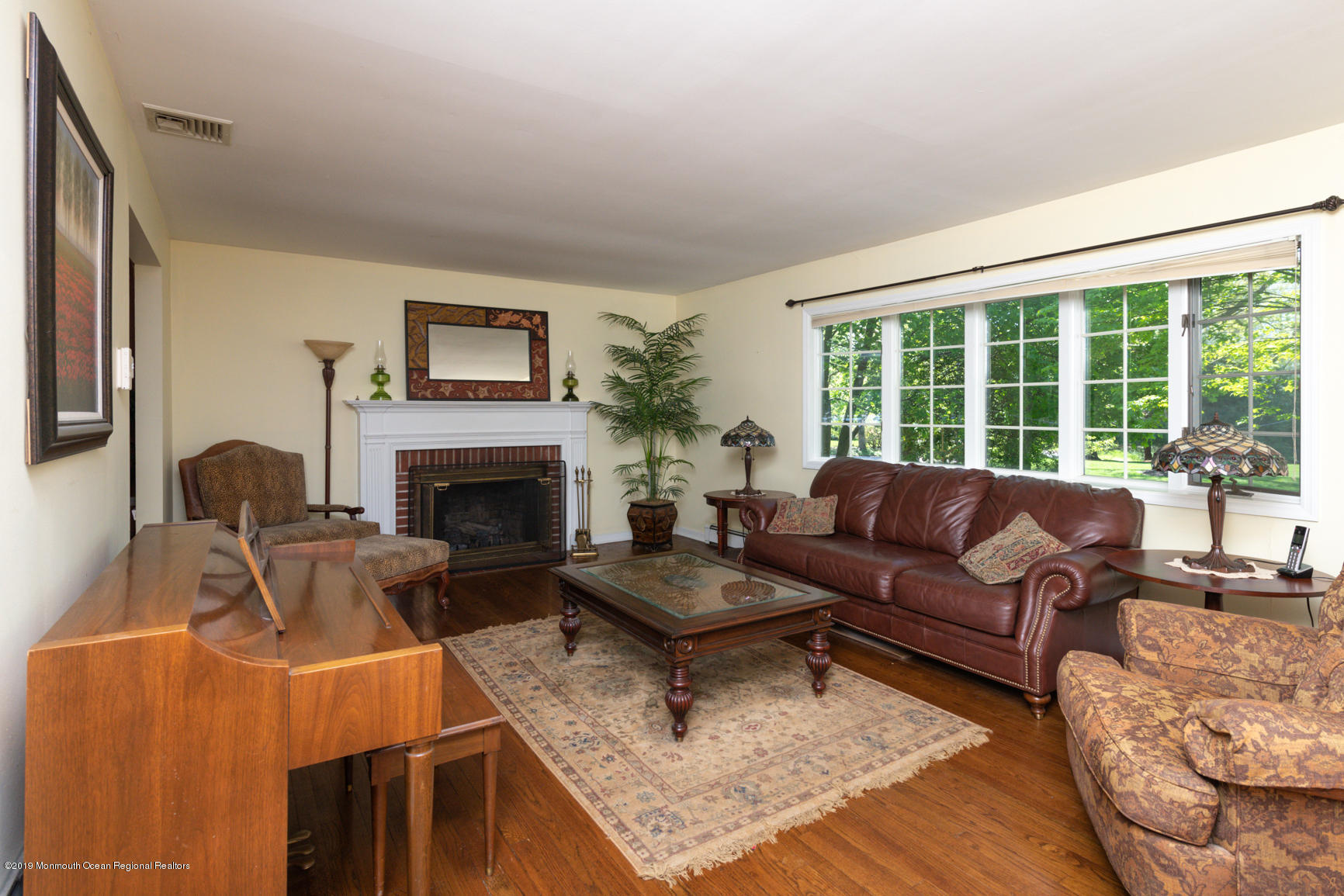 10 Gull Road Middletown, NJ 07748 - Photo 5 of 18 a living room with furniture and a fireplace