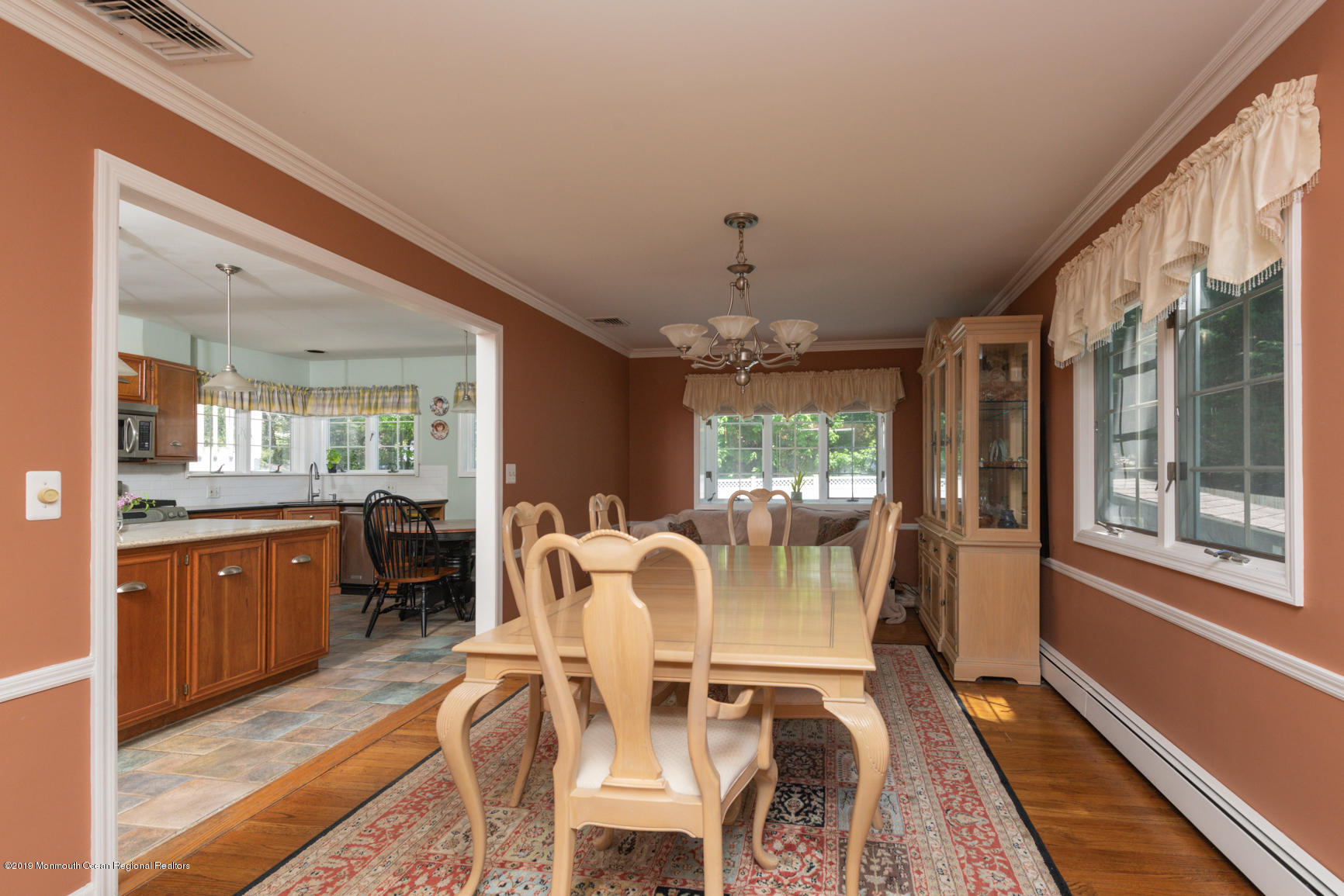 10 Gull Road Middletown, NJ 07748 - Photo 7 of 18 a view of a dining room with furniture a chandelier and wooden floor