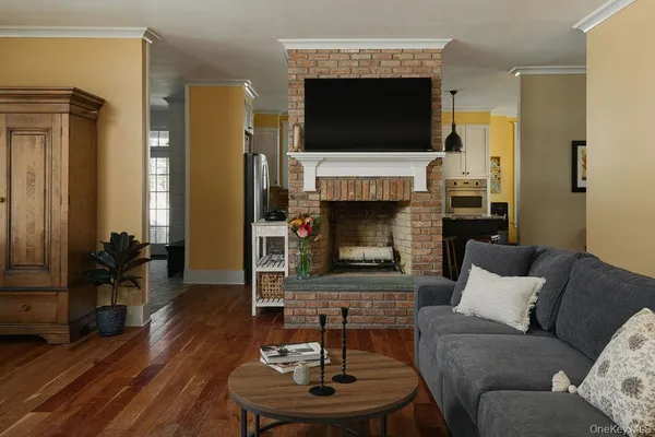 a living room with furniture a fireplace and a flat screen tv