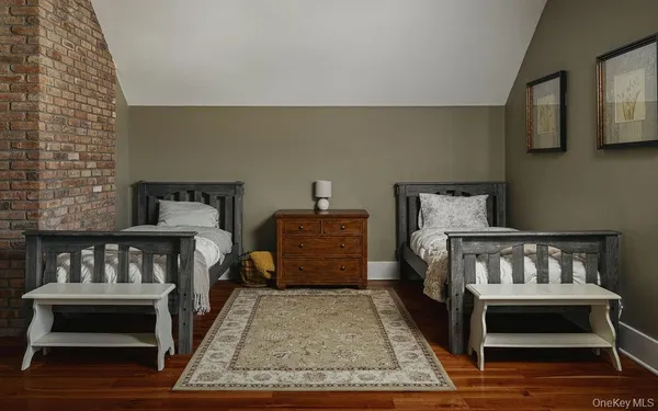 a bedroom with furniture and a rug