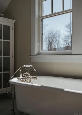 a view of a livingroom with wooden floor and a window