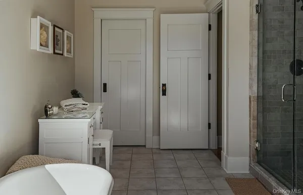 a bathroom with a toilet a sink a shower and mirror
