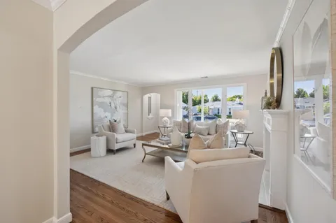 a kitchen with stainless steel appliances kitchen island granite countertop a refrigerator a stove a sink dishwasher with a dining table and chairs