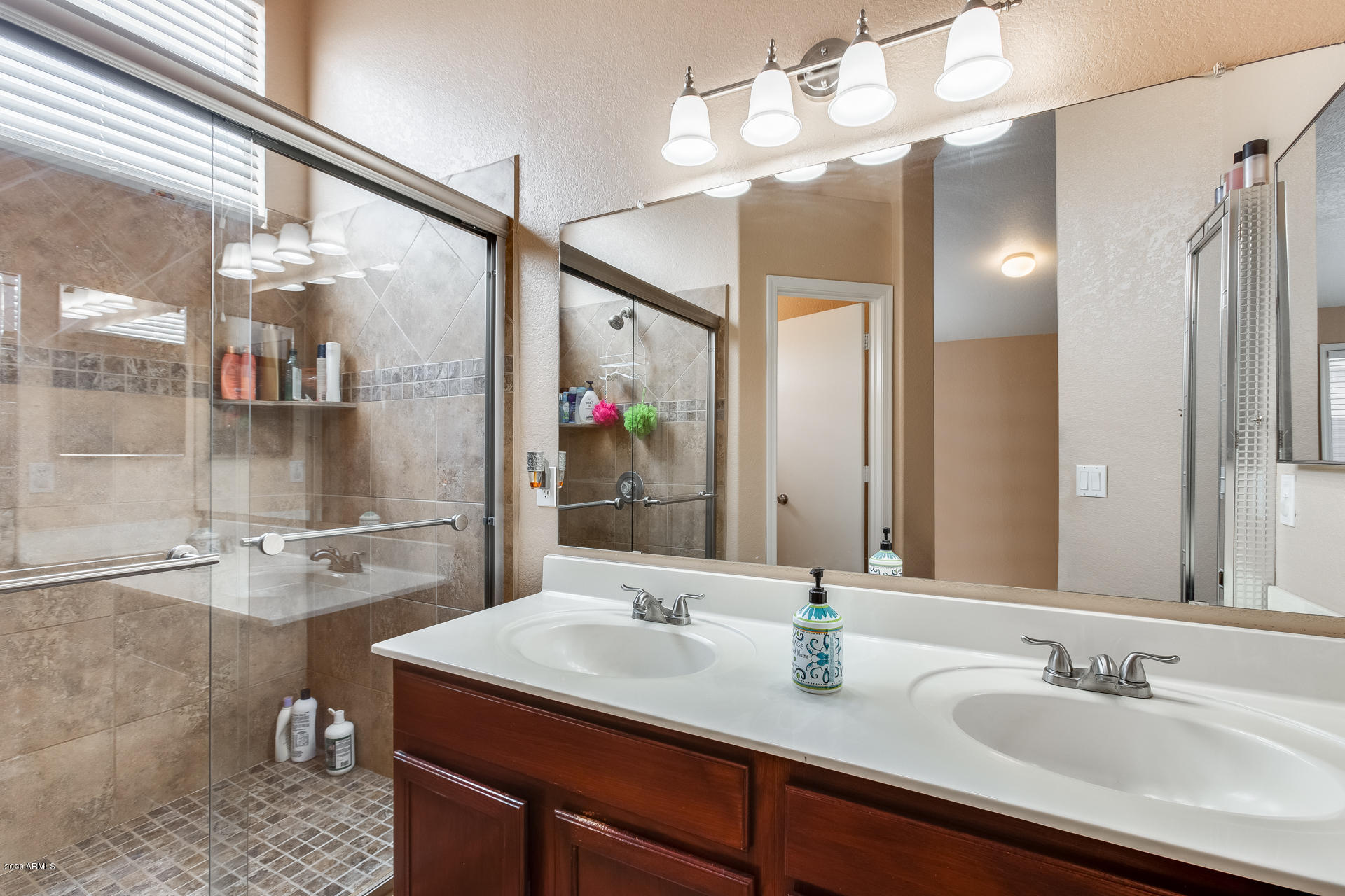8713 West Coronado Road Phoenix, AZ 85037 - Photo 15 of 27 a bathroom with a sink vanity granite and a mirror