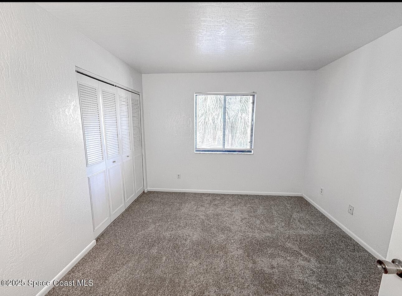2130 Forest Knoll Drive Northeast, Unit 30208 Palm Bay, FL 32905 - Photo 12 of 19 an empty room with windows