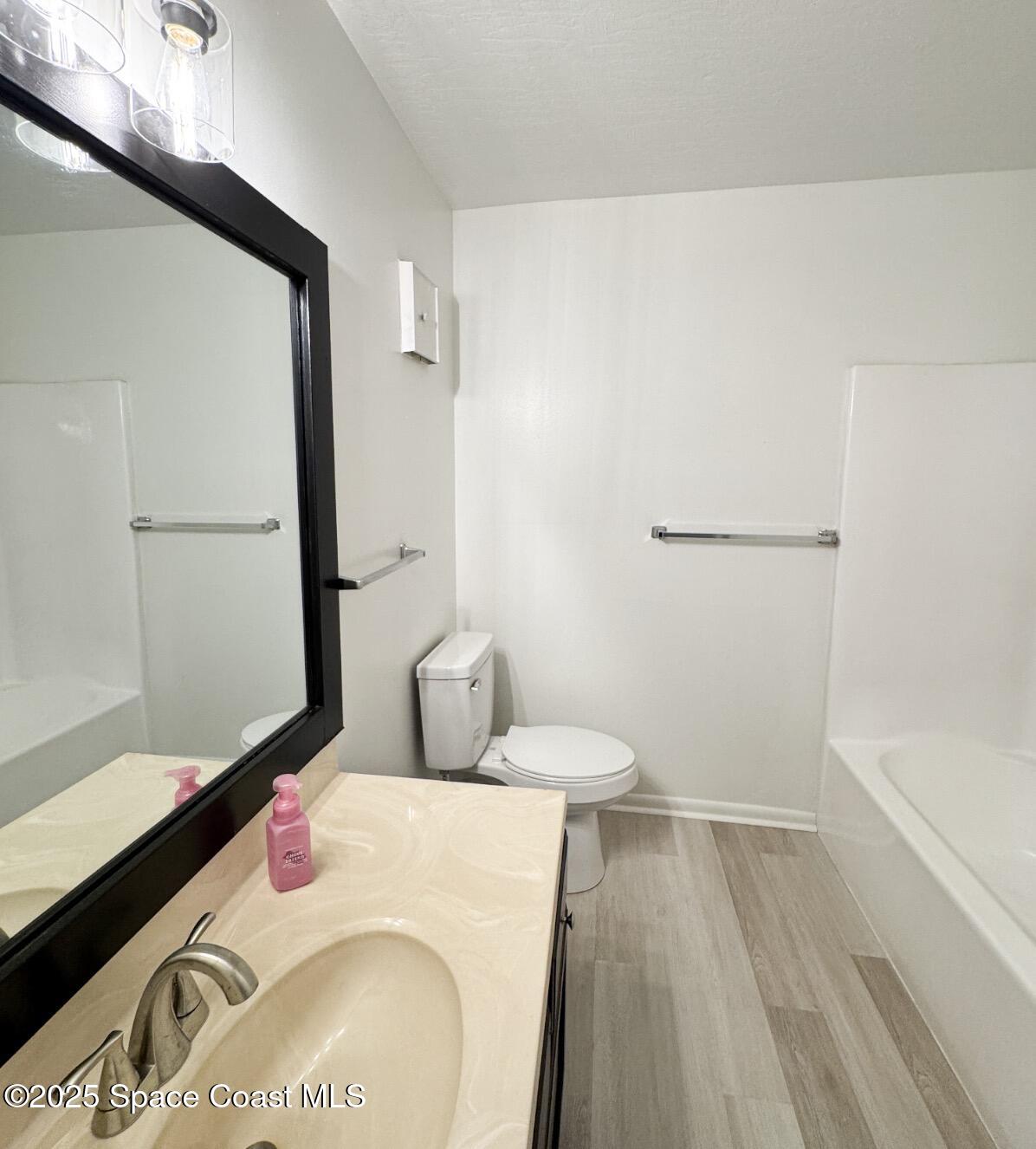 2130 Forest Knoll Drive Northeast, Unit 30208 Palm Bay, FL 32905 - Photo 13 of 19 a bathroom with a sink and a mirror