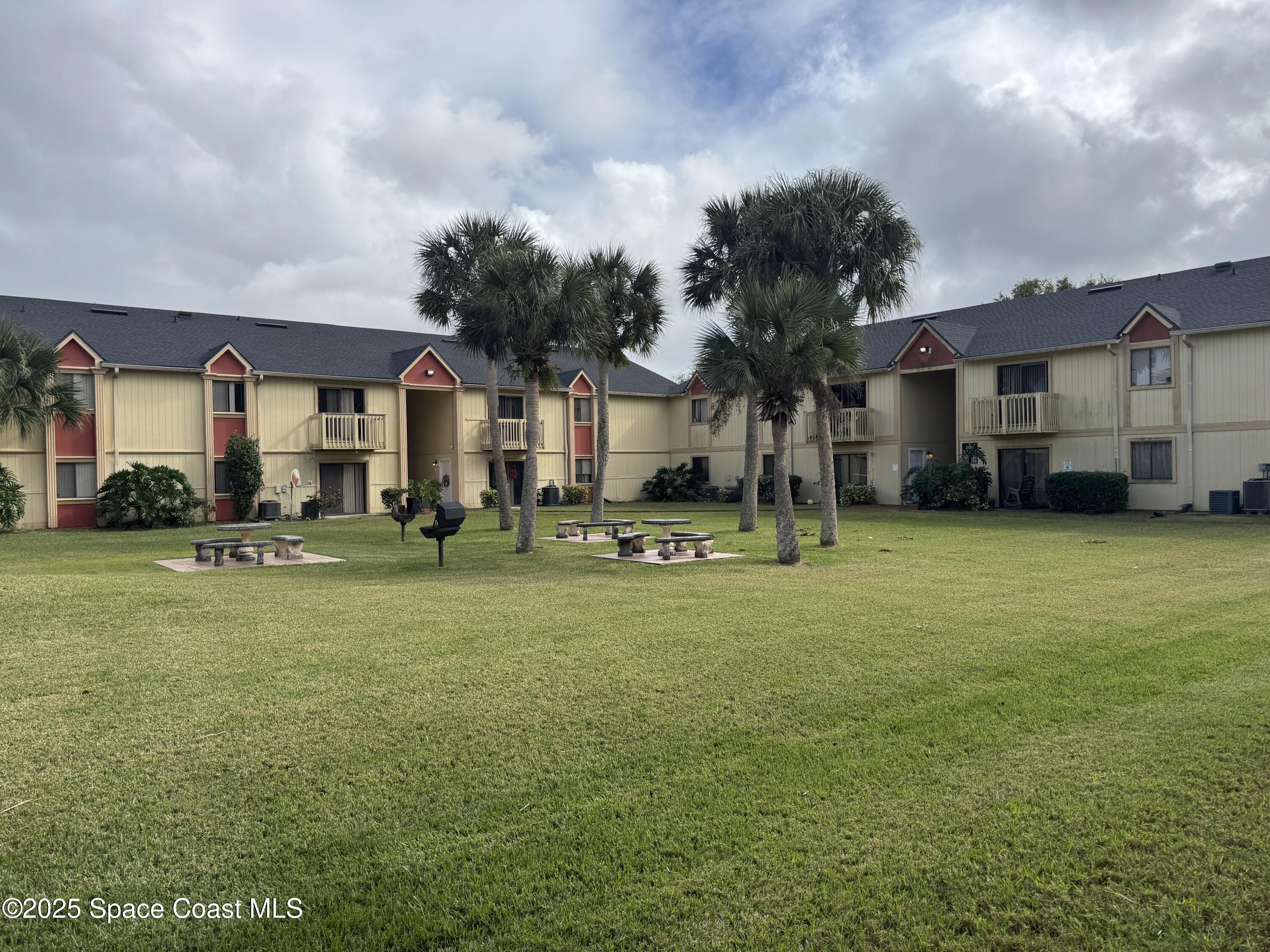 2130 Forest Knoll Drive Northeast, Unit 30208 Palm Bay, FL 32905 - Photo 2 of 19 a front view of house with yard