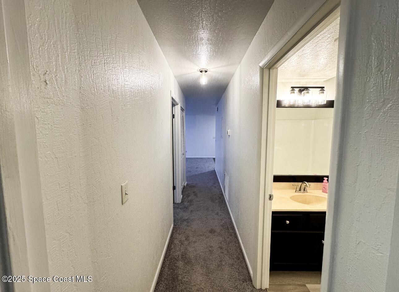 2130 Forest Knoll Drive Northeast, Unit 30208 Palm Bay, FL 32905 - Photo 8 of 19 a view of a hallway with wooden floor